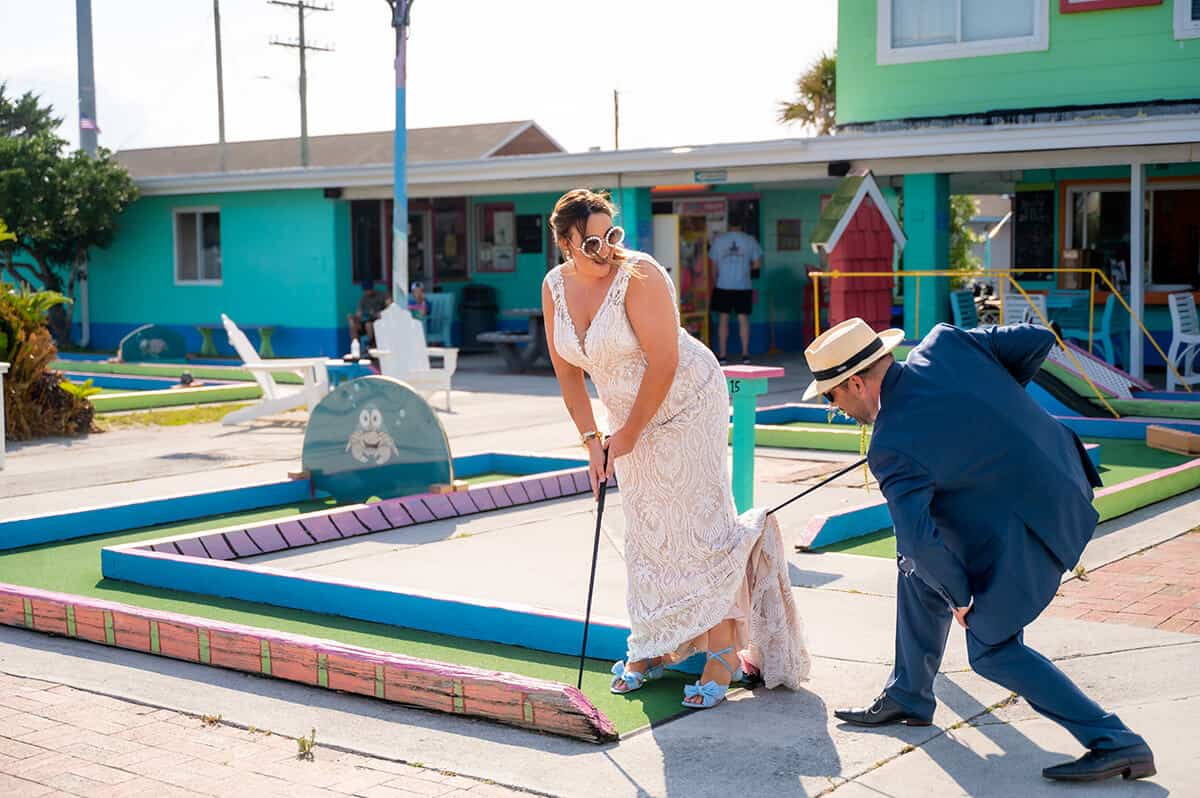bride and groom playing mini gold at Topsail Beach, North Carolina