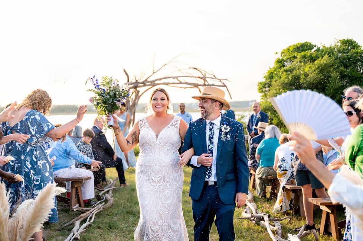 bride and groom walk down aisle after Topsail Beach Wedding designed by Local Revival