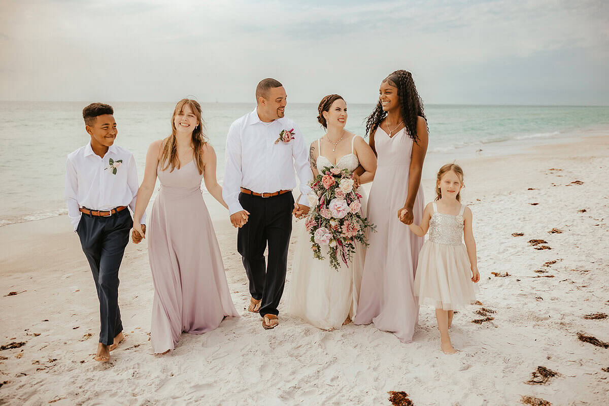 Bride and groom exchanged vows at a scenic beach with their families in Tampa Bay.